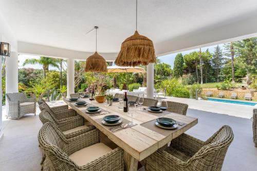 a dining room with a wooden table and chairs at Villa Natura by Algarve Holidays in Vilamoura