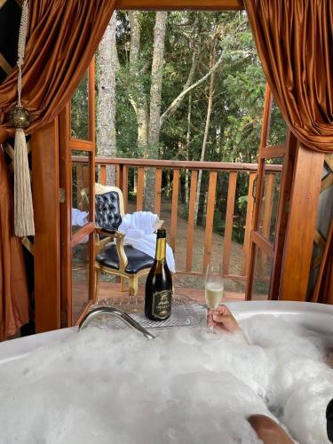 a bottle of champagne in a tub on a deck at Glamping montain experience in São Joaquim