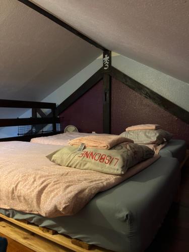 a bed with a wooden frame in a room at Dallas garden in Strasbourg