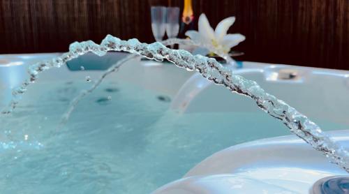 a bathtub filled with blue water with at Casa Boutique Luxury Yumbo in Playa del Ingles