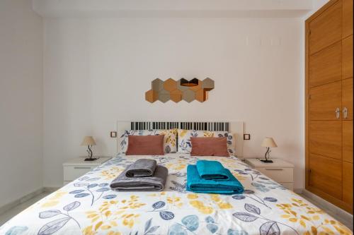 1 dormitorio con 1 cama con 2 toallas en Apartamento Moderno Con Wifi Gratis, en Sevilla