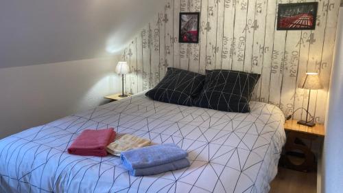 a bedroom with a bed with two towels on it at Katy's Home Dinard in Dinard