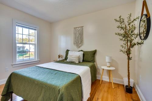 a bedroom with a bed with a green blanket at Charming Boho Home Near OSU, Short North, Downtown in Columbus