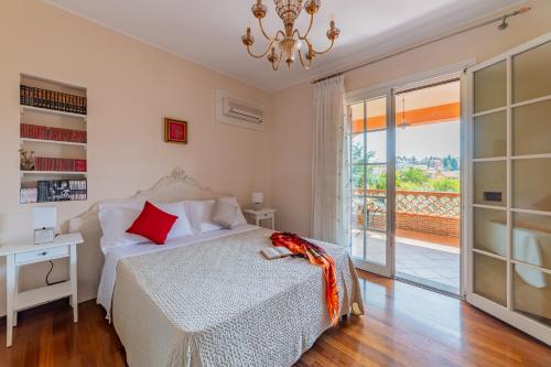 a bedroom with a bed and a chandelier at Villa Rita Taormina in Taormina