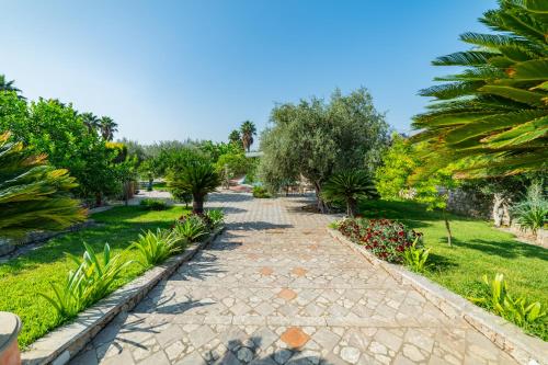 a path in a park with trees and plants at Villa Rita Taormina in Taormina