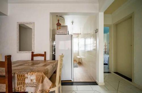 a room with a bed and a refrigerator at Residencial Primavera in Balneário Camboriú