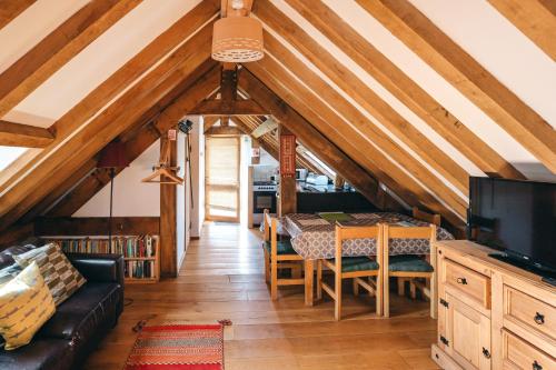 a dining room with a table and a couch at the garden room in Shrewsbury