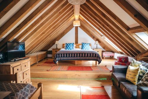 a attic room with a bed and a tv at the garden room in Shrewsbury