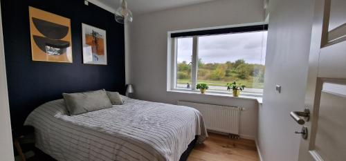 a bedroom with a bed and a window at Modern, fully equipped flat in Copenhagen