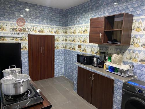 a kitchen with a pot on a stove top oven at Dex & Flex Apartments 2 in Ibadan