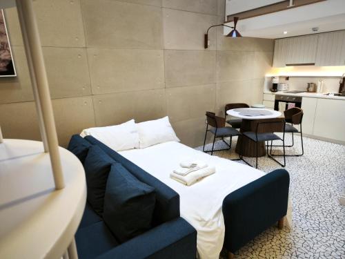 a room with a bed and a table and a kitchen at Trueman Court Luxury Serviced Apartments in Liverpool