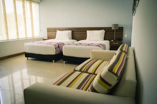Un pat sau paturi într-o cameră la Malik Hotel Boutique