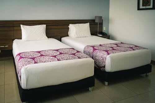 Un pat sau paturi într-o cameră la Malik Hotel Boutique