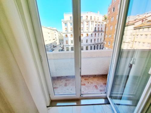 a large window with a view of a city at The Gallery Boutique Rooms in Trieste