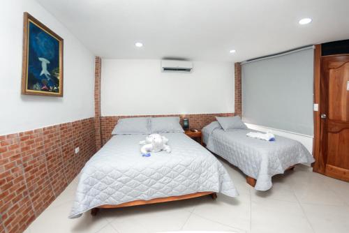 a bedroom with two beds with stuffed animals on them at Fernandina Hotel & Spa in Puerto Ayora