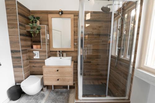 a bathroom with a shower and a toilet and a sink at George&Dragon Rooms in Bucharest