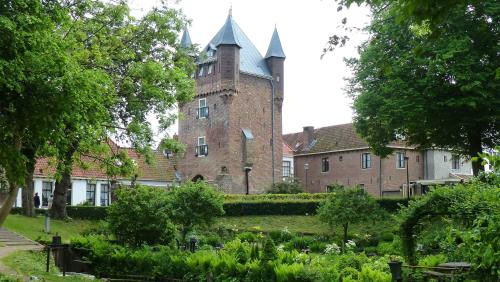 a large brick building with a tower on top at Molecaten Park De Leemkule in Hattem