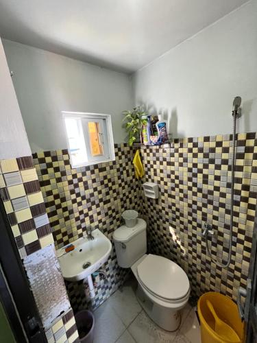 a bathroom with a toilet and a sink at JC Unit #5 