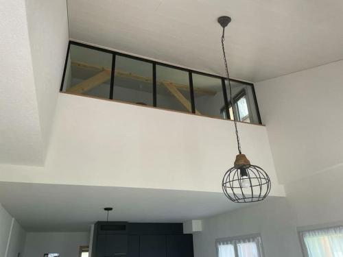 a room with a light hanging from a ceiling at Coup d'œil in Bullet