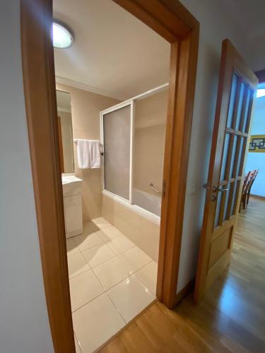 a bathroom with a toilet and a window and a door at Apartamento Costa Do Sol V in Funchal