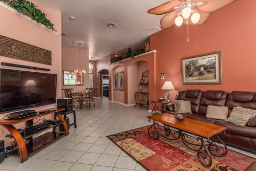 a living room with a couch and a tv at 2217 Wyndham Palms in Kissimmee