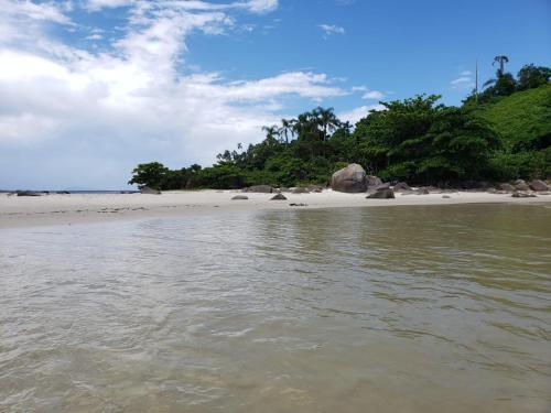een strand met rotsen en bomen en het water bij Pousada Ilha das Peças LG in Fortaleza
