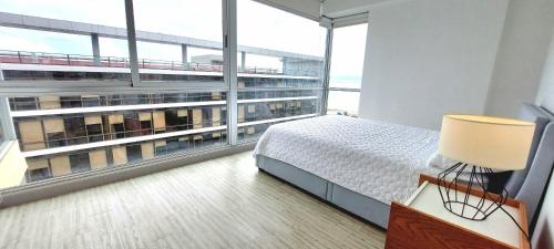 a bedroom with a bed and a large window at Splendid Apartment City Center - PH Quartier Atlapa in Panama City