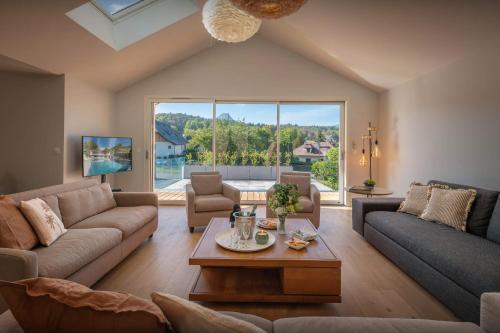 a living room with a couch and a table at Villa Trois Lauriers - OVO Network in Écharvine