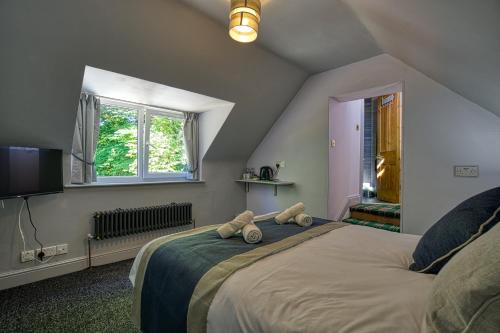 a bedroom with a large bed with two teddy bears on it at Woodlands Bed and Breakfast in Dornoch
