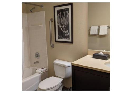 a bathroom with a white toilet and a sink at Escape to Tropicana, a Tranquil Condo Oasis Near the LV Strip - Special Offer Now! in Las Vegas
