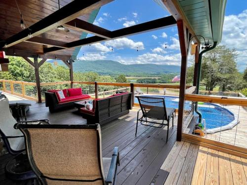 a deck with a couch and chairs and a pool at Heaven’s View Lodge, Pool, Pet Friendly in Dunlap