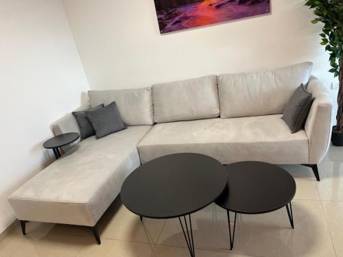 a living room with a couch and two tables at The best location in Jerusalem 1 in Jerusalem
