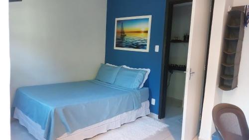 a blue bedroom with a bed in a room at Lofts da Monica in Rio de Janeiro