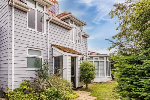 a white house with a garden in front of it at Seaview in Mundesley