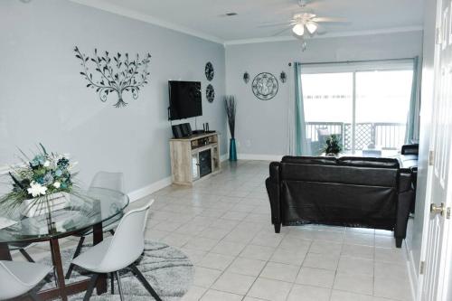 a living room with a glass table and a couch at Scenic Carolina Waterfront Rentals - Arco in Charleston