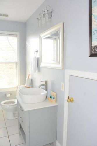 a white bathroom with a sink and a toilet at Scenic Carolina Waterfront Rentals - Arco in Charleston