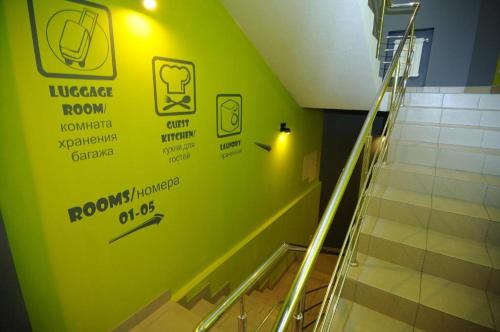 a green wall in a hallway with a staircase at DREAM Hotel Kyiv in Kyiv