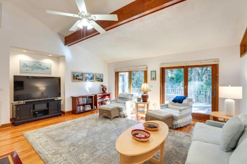 a living room with a couch and a tv at Spacious Kiawah Island Home with Deck, Walk to Beach in Johns Island