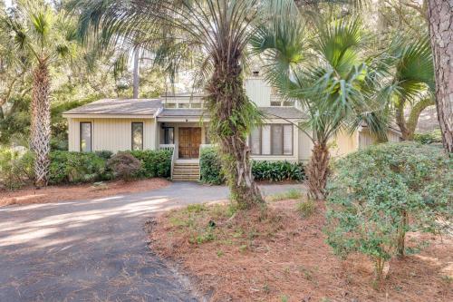 a house with palm trees in front of a driveway at Spacious Kiawah Island Home with Deck, Walk to Beach in Johns Island