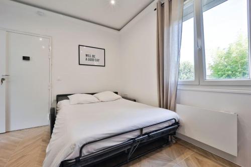 - une chambre blanche avec un lit et une fenêtre dans l'établissement Le Joyau - App 4 personnes, à Limeil-Brévannes