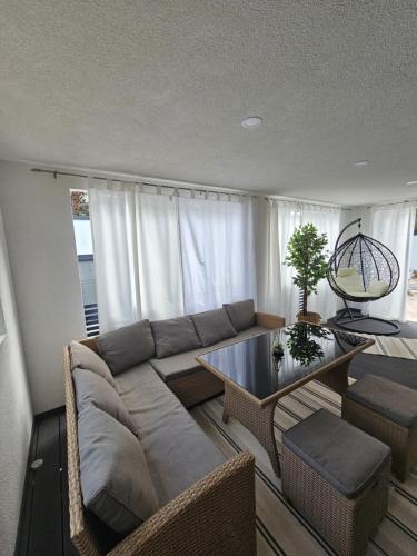 a living room with a couch and a table at FJAKA luxury mobile home - Oaza Mira Camping Croatia in Drage