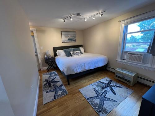a bedroom with a bed and two rugs at Bright & Spacious 1 BR- King Bed & Private Yard in Providence