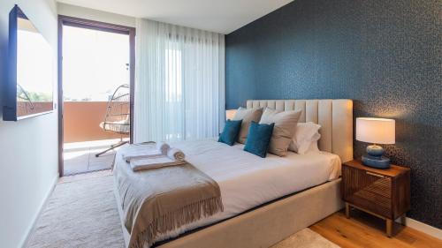 a bedroom with a large bed with a large window at Casa do Sol by LovelyStay in Vila Nova de Gaia