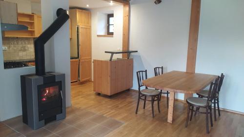 a living room with a wood stove and a table at Apartment 7 