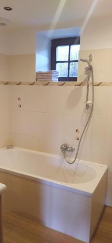 a bathroom with a bath tub and a window at Apartment 7 