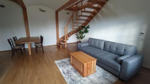 a living room with a blue couch and a table at Apartment 7 