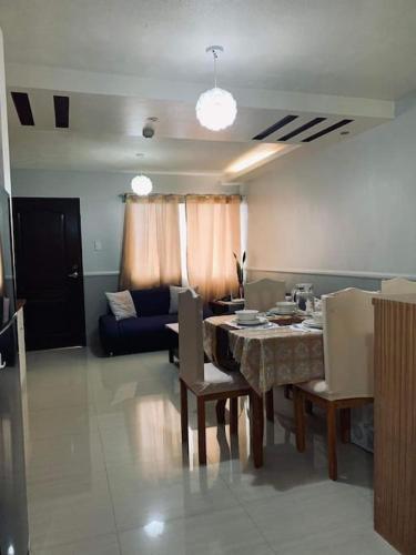 a living room with a table and a couch at Appartement: 2 BR at One Oasis in Davao City