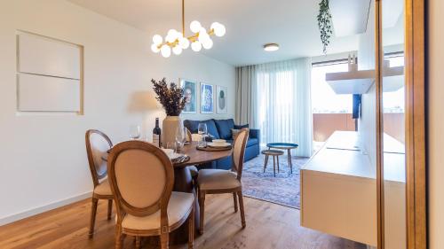 a dining room and living room with a table and chairs at Casa do Sol by LovelyStay in Vila Nova de Gaia