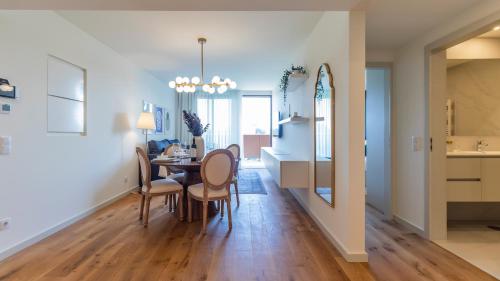 a dining room and living room with a table and chairs at Casa do Sol by LovelyStay in Vila Nova de Gaia