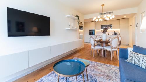 a living room with a blue couch and a table at Casa do Sol by LovelyStay in Vila Nova de Gaia